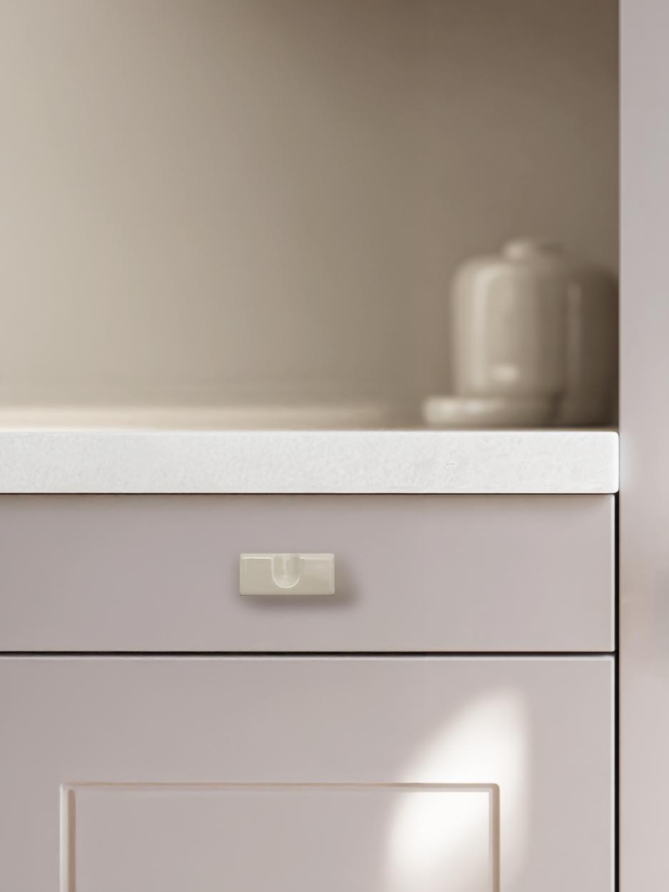 Simple white rectangle knobs for contemporary cabinets drawers.