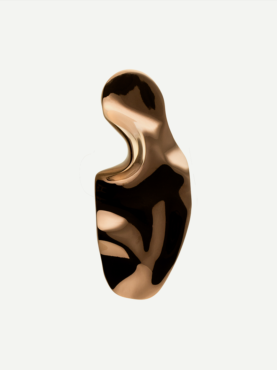 Sculptural brass knobs for luxury bathroom cabinets.
