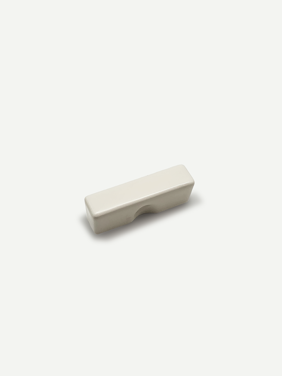 Modern rectangular white knobs for kitchen drawers.