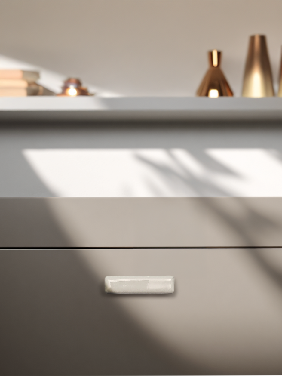 White rectangular cabinet knobs for kitchen drawers.